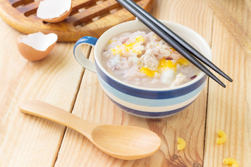 Traditional chinese brown rice gruel in white bowl, congee