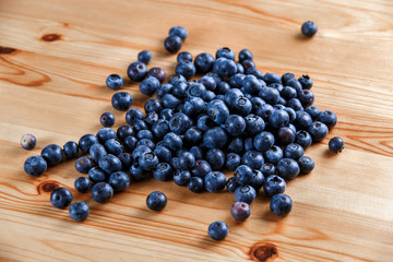 Fresh Organic Blueberries on wooden table. Background