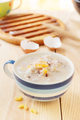 Traditional chinese brown rice gruel in white bowl, congee
