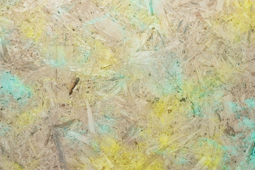 Close-up of pressboard background with green yellow