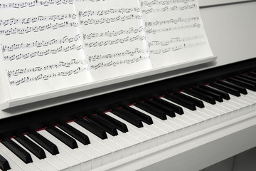 Piano with music notes close up