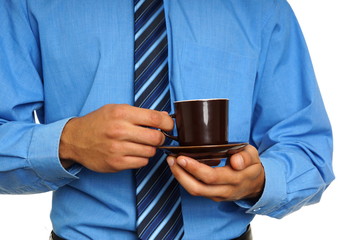 Businessman in blue shirt, holds cup of coffee