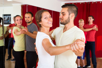 Romantic couple dancing in dancing school