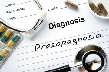 Diagnostic form with diagnosis Prosopagnosia  and pills.