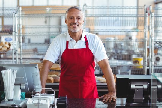 Barista Smiling At Camera Behind Counter