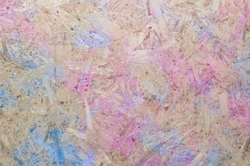 Close-up of pressboard background with blue pink