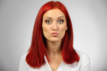 Beautiful young woman on gray background