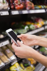 Woman buy products and using his smartphone 