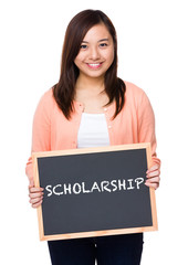 Asian woman with black board showing a word scholarship