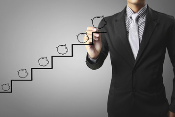 Businessman drawing piggy bank