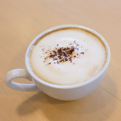 hot coffee on wooden table in the cafe