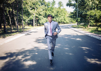 Businessman running in park