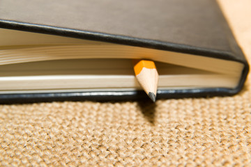 notebook and pencil on the old tissue
