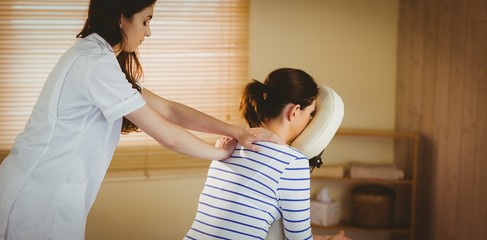 Young woman getting massage in chair