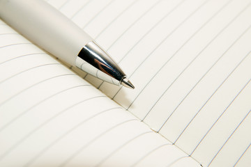 Notepads and pen on a white background
