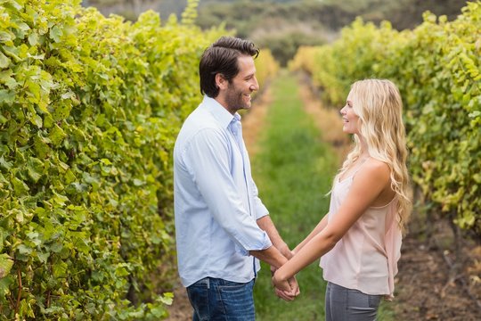 Young happy couple holding hands