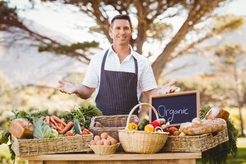 Smiling farmer presenting the local products