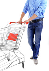 Young man with empty shopping cart, isolated on white