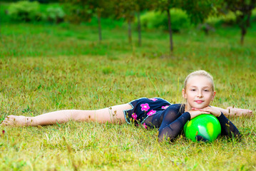 flexible little blondie girl doing gymnastics horizontal split