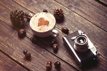 Fototapeta na wymiar Cup of coffee on wooden background