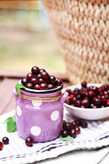 Red gooseberry in pail outdoors