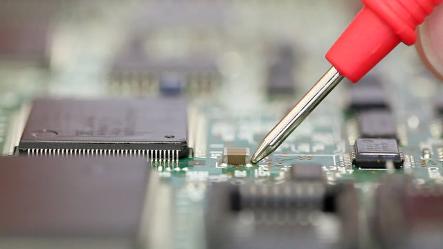 Close up of electronics engineer checking a circuit board