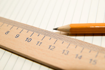 Notepads, pencil and wooden ruler on a white background