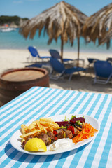Tuna meal/Grilled tuna on plate with decorative vegetable and potato. Plaid cloth background.