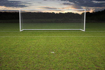 empty amateur football goal posts and nets shot at sunset - obrazy, fototapety, plakaty