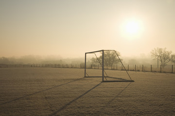 empty football pitch and goal on a frosty winter morning sunrise © jasoncoxphotography