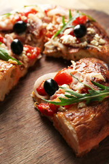 Piece of homemade pizza on wooden board background