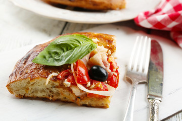 Piece of homemade pizza on wooden board background