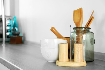 Composition with different utensils on wooden wooden table in kitchen