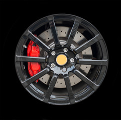 Sports car rim isolated on black background.