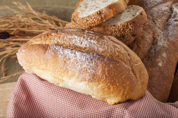Bread, a set of variation of breads on a wood chopping block with a brass knife