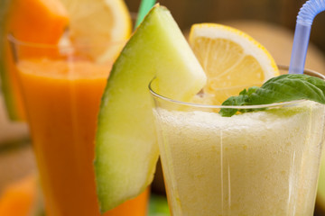 Cantaloupe smoothie or milkshake with fruit and lemon