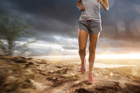 Woman runs in a rocky landscape