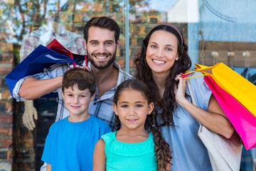 Fototapeta premium Portrait of a happy family with shopping bags