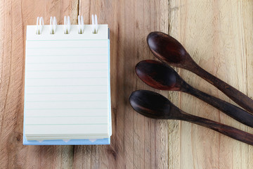 Notebook and wooden spoon.