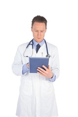 Serious doctor using a digital tablet