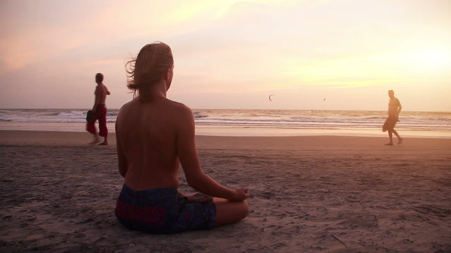 Man meditating at sunset 