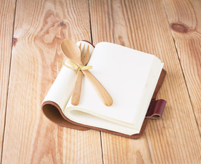 White open notebook on wood background