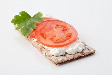 Knäckebrot mit Tomatenscheiben, Petersilie und Frischkäse