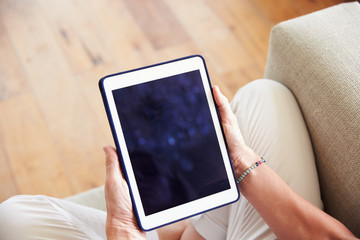 Close Up Of Woman Using Digital Tablet At Home