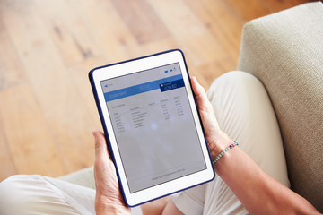 Woman Looking At Banking App On Digital Tablet