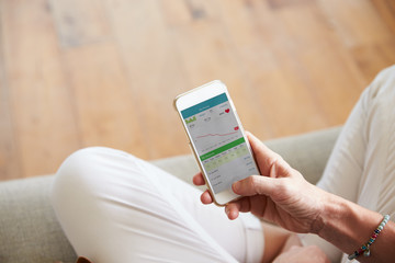 Woman Looking At Health Monitoring App On Smartphone © Monkey Business