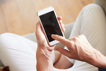 Close Up Of Woman Using Smartphone At Home