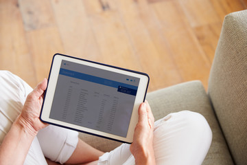 Woman Looking At Banking App On Digital Tablet
