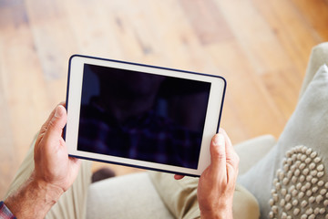 Close Up Of Man Using Digital Tablet At Home