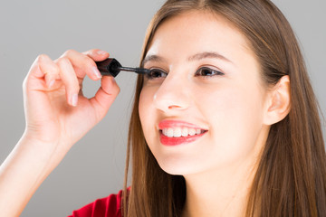 Woman applying mascara